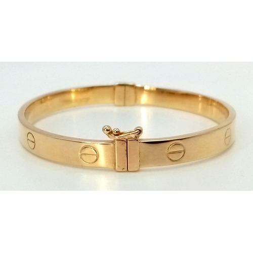 874 - A 9K Yellow Gold Cartier-Style Bangle. 6cm inner diameter. 8.5g.