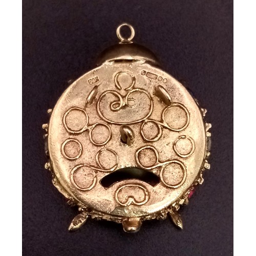 938 - A 9K GOLD CLOCK PENDANT OR CHARM DECORATED WITH GEMSTONES .  12gms