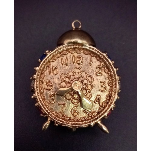 938 - A 9K GOLD CLOCK PENDANT OR CHARM DECORATED WITH GEMSTONES .  12gms