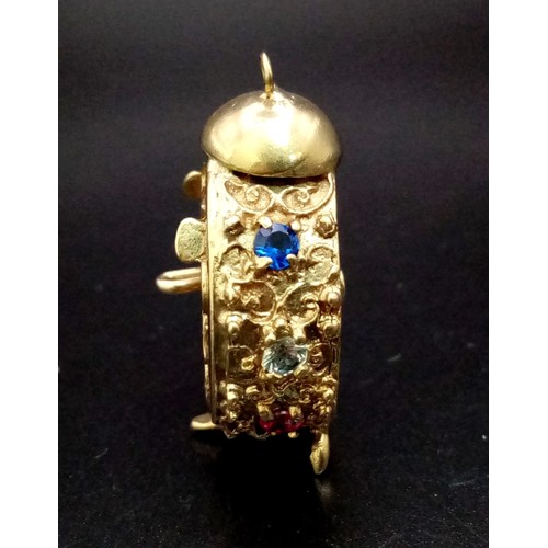 938 - A 9K GOLD CLOCK PENDANT OR CHARM DECORATED WITH GEMSTONES .  12gms