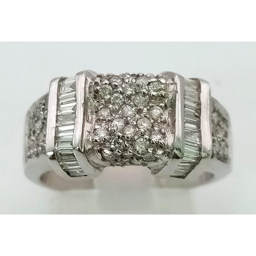 937 - An 18K White Gold, Round and Baguette Cut Diamond Cluster Ring. Wonderful belt-buckle effect. Size N... 