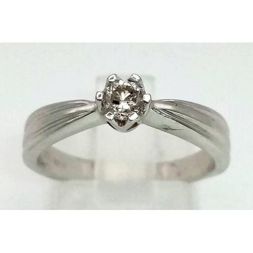 945 - A 9K White Gold Diamond Solitaire Ring. 0.10ct. Size N. 3.8g total weight.