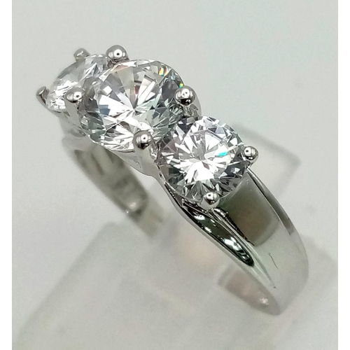 1013 - A 9K WHITE GOLD RING WITH SPARKLING ZIRCONIA STONES .   4.4gms   size O