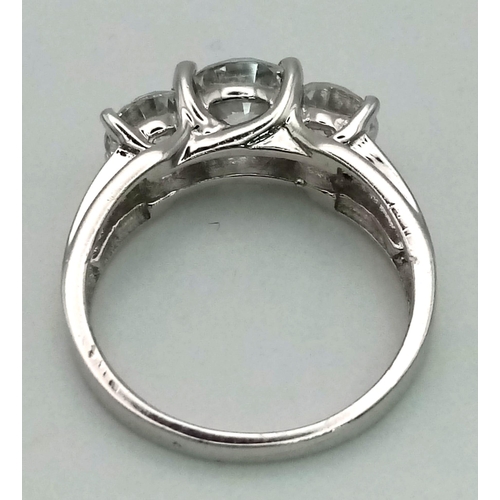 1013 - A 9K WHITE GOLD RING WITH SPARKLING ZIRCONIA STONES .   4.4gms   size O