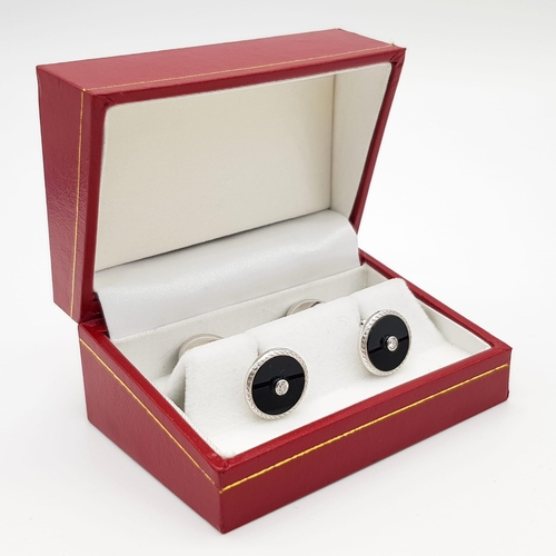 1014 - A Pair of Edwardian 18K White Gold Diamond and Onyx Cufflinks. Makers mark of Deakin and Francis. 11... 