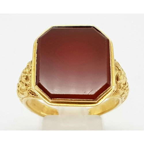 63 - An 18K Yellow Gold Victorian Carnelian Signet Gents Ring. Large hexagonal carnelian with rich scroll... 