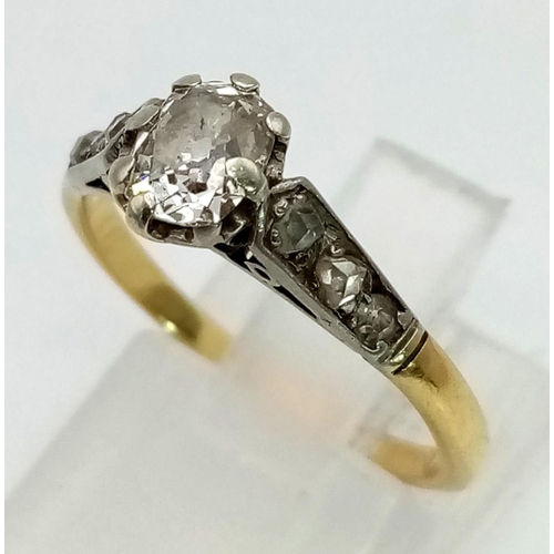 307 - A 9K Yellow Gold Diamond Ring. Central oval diamond with a further compliment of three diamonds on e... 