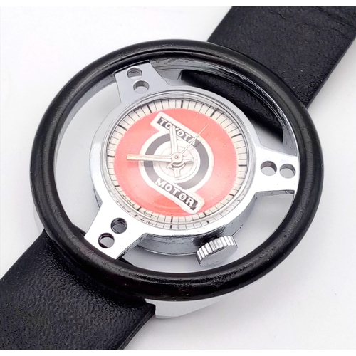 686 - A RARE COLLECTERS WATCH THE TOYOTA MOTOR WRIST WATCH IN THE SHAPE OF A STEERING WHEEL..