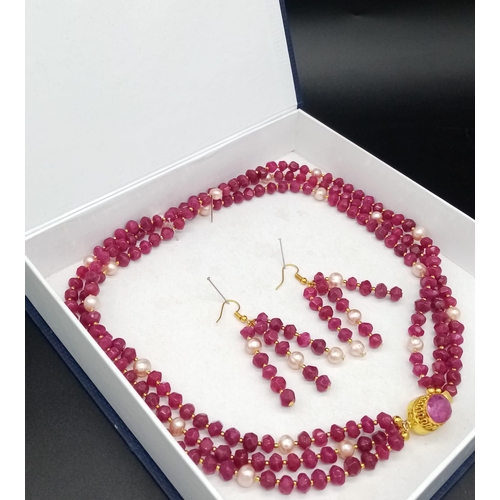 181 - A glorious, three strand necklace with multifaceted rubies and pink natural pearls, with large clasp... 