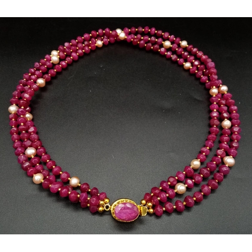 181 - A glorious, three strand necklace with multifaceted rubies and pink natural pearls, with large clasp... 