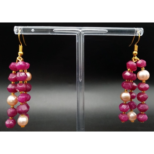 181 - A glorious, three strand necklace with multifaceted rubies and pink natural pearls, with large clasp... 