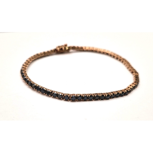 1021 - A 9K ROSE GOLD TENNIS BRACELET WITH 67 BLACK DIAMONDS TOTALLING 4ct  8.8gms  19cms .