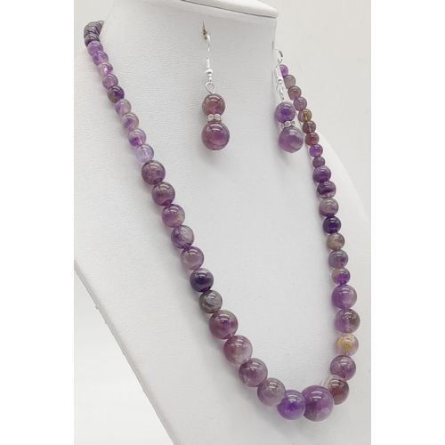 1482 - An Amethyst Graduated Bead Necklace With Matching Ball-Drop Earrings. Largest bead - 14mm. Earring d... 