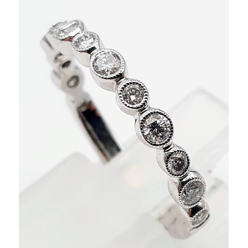 1459 - A 9K WHITE GOLD AND DIAMONDS HALF ETERNITY RING .  2.2gms   size M