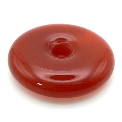 1478 - A Red Jade Doughnut Pendant. 30mm diameter.