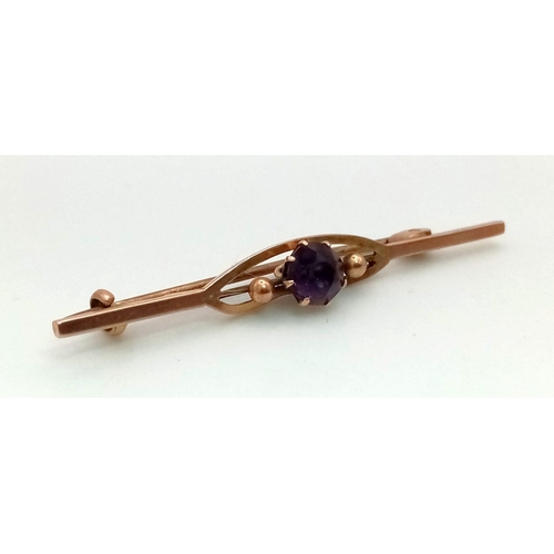 1475 - An Antique Victorian 9K Rose Gold and Amethyst Bar Brooch. 
5cm. 1.89g total weight.