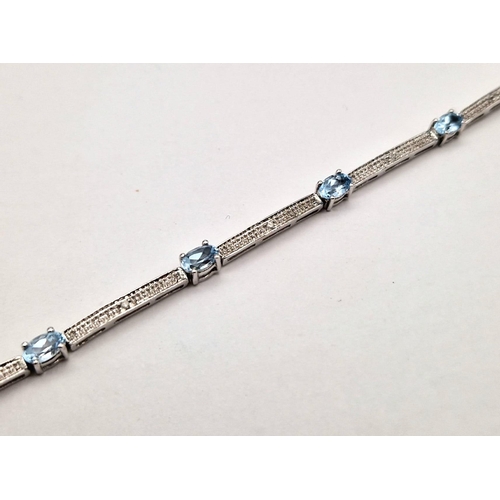 1462 - A 9K WHITE GOLD VERY PRETTY AQUA MARINE BRACELET.  5,9gms   19cms