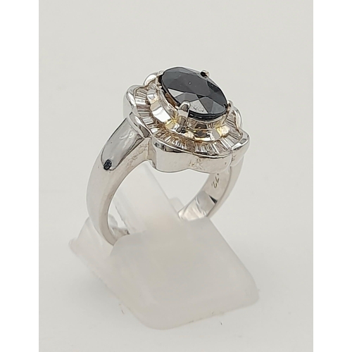 1307 - A Beautiful Vintage 18K White Gold, Sapphire and Diamond Ring. Central oval sapphire with a baguette... 