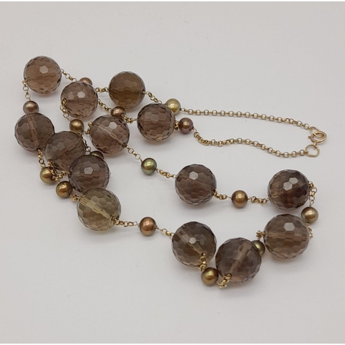 1343 - 9K Gold and Smokey Quartz Necklace. 61grams. 58cm in length.