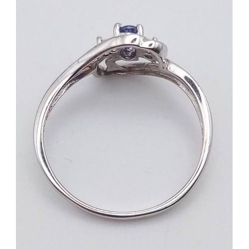 1450 - A 9K WHITE GOLD RING WUTH BLUE AND WHITE STONES. 1.6gms   size P