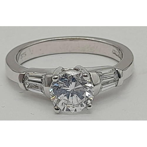 1418 - A 9K WHITE GOLD RING WITH SPARKLING ZIRCONIA STONES.   4.3gms   size M