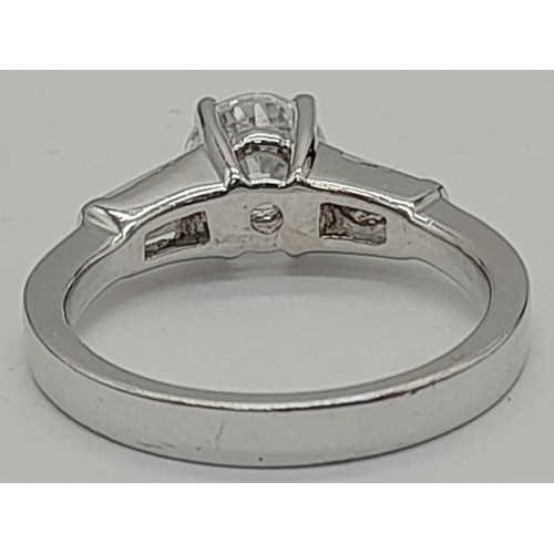 1418 - A 9K WHITE GOLD RING WITH SPARKLING ZIRCONIA STONES.   4.3gms   size M