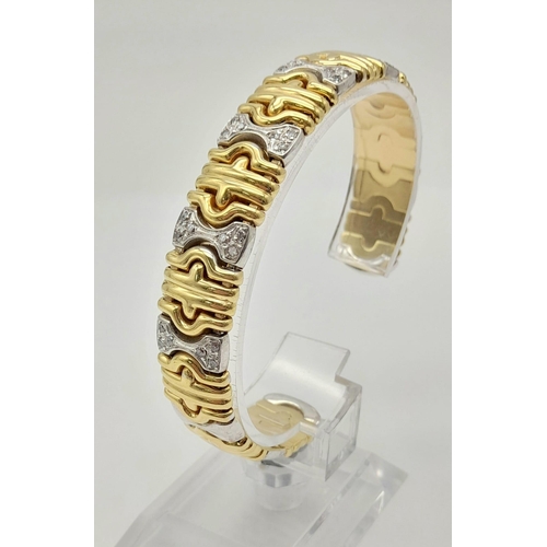 1319 - AN 18K GOLD AND DIAMOND ITALIAN DESIGNER BANGLE.  37.7gms