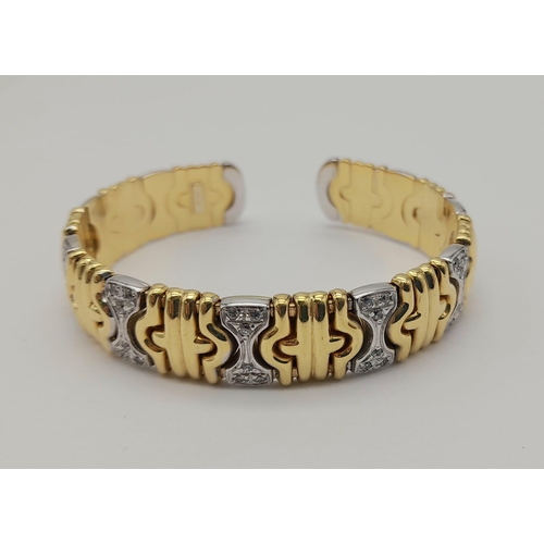 1319 - AN 18K GOLD AND DIAMOND ITALIAN DESIGNER BANGLE.  37.7gms