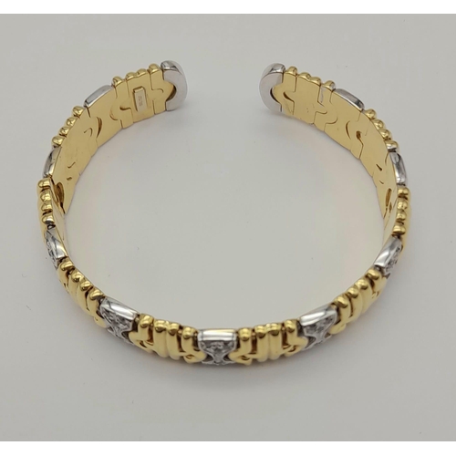 1319 - AN 18K GOLD AND DIAMOND ITALIAN DESIGNER BANGLE.  37.7gms