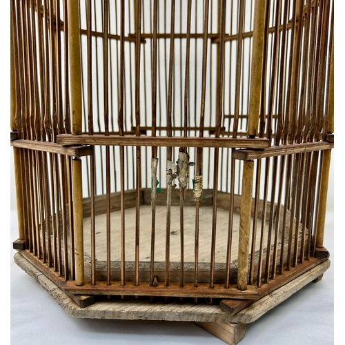 44 - A VERY RARE ANTIQUE CHINESE BAMBOO BIRD CAGE FROM THE LATE 1800'S . HIGH HEXAGONAL DESIGN AND IN VER... 