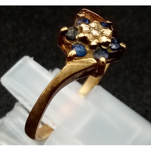 613 - An Antique 9K Gold Sapphire and Diamond Ring. Six old cut sapphires and a small diamond. Size P. 2.0... 