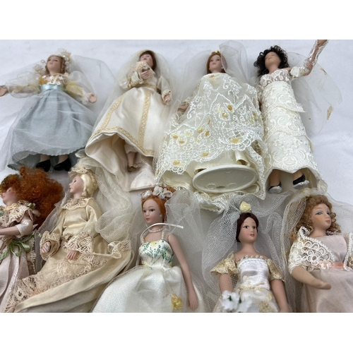 1239 - A Collection Of 9 Dolls in wedding Dresses, all 19cm including the tiara and stand.