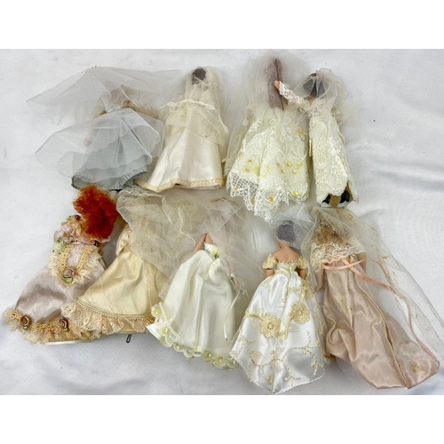 1239 - A Collection Of 9 Dolls in wedding Dresses, all 19cm including the tiara and stand.