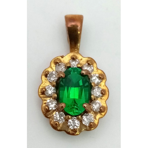 561 - A Vintage 9K Yellow Gold Emerald and Diamond Pendant. 2cm. 1.1g