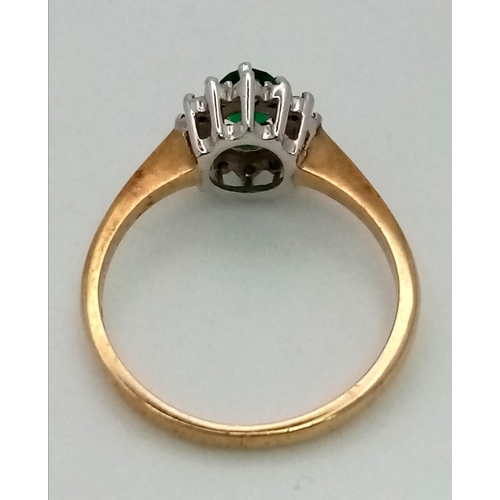 634 - A Vintage 9K Yellow Gold Emerald and Diamond Ring. Central oval emerald with a diamond surround. Siz... 