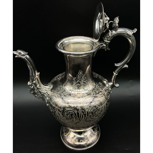 955 - An Antique Ornate Elkington and Co Silver Plate Coffee Pot. 
Scroll engraving on body with a birds h... 