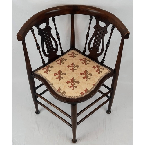 1302 - A VICTORIAN CORNER CHAIR TASTEFULLY REUPHOLSTERED WITH CURVED BACK REST ON HARP SHAPED STRUTTS.