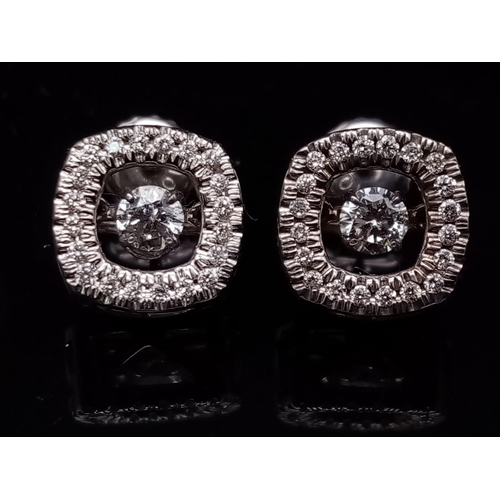 106 - A 10K white gold pair of diamond earrings with moving parts. made in USA with original box.