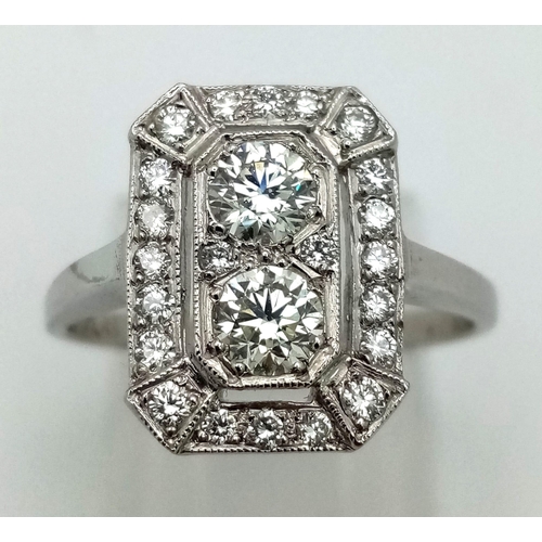 1083 - An Art Deco platinum ring with two beautiful brilliant cut diamonds surrounded by a halo of diamonds... 