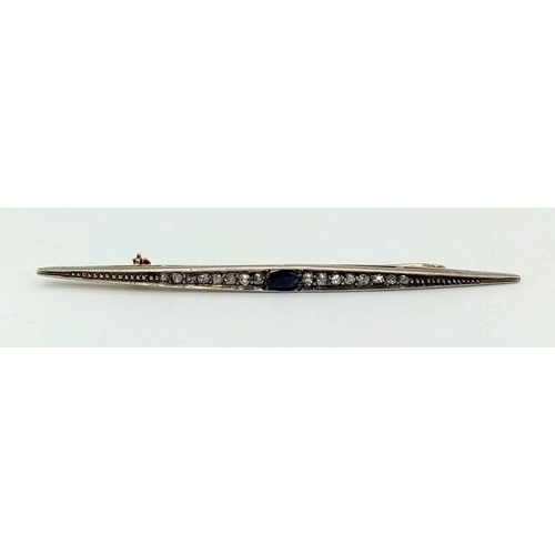 120 - An antique yellow and white gold brooch with old cut diamonds and a blue sapphire. Length: 80 mm. In... 