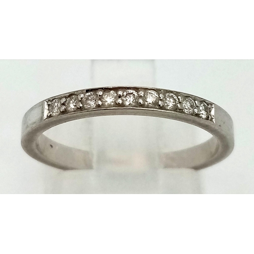 127 - An 18K white gold half eternity ring with diamonds. Ring size: m, weight: 2.54 g.