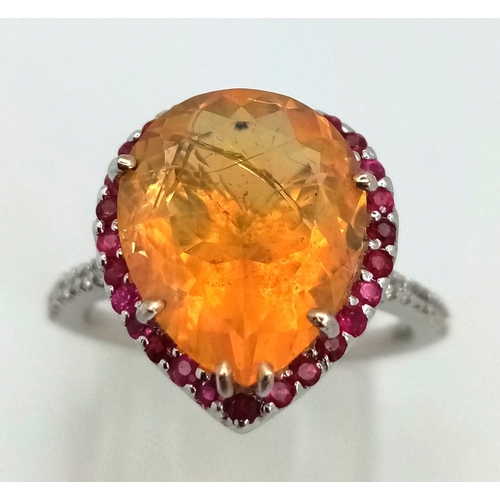 141 - An 18K white gold ring with a pear cut fire opal surrounded by rubies and diamonds on the shoulders ... 