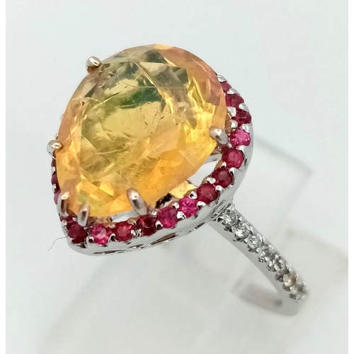 141 - An 18K white gold ring with a pear cut fire opal surrounded by rubies and diamonds on the shoulders ... 