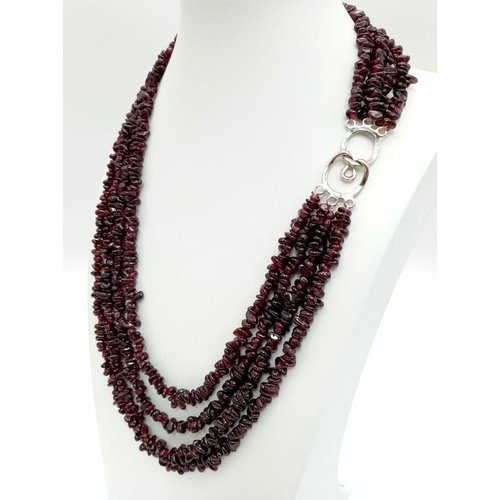 286 - A very feminine four strand garnet necklace. Length: 47-57 cm, weight: 130 g.