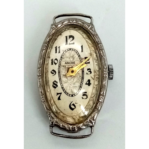 428 - A vintage, 14K white gold ladies watch. Oval case 27 x 16 mm, with gold tone hands.