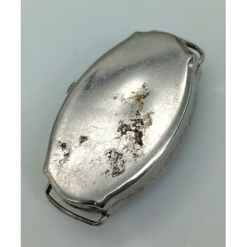 428 - A vintage, 14K white gold ladies watch. Oval case 27 x 16 mm, with gold tone hands.