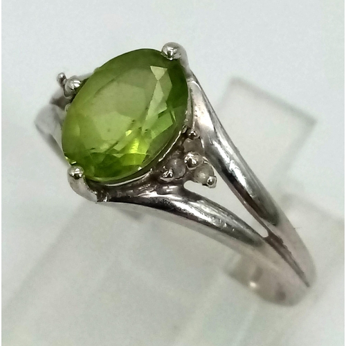 446 - A Vintage 9K White Gold Peridot Ring. Size N. 2.46g total weight.