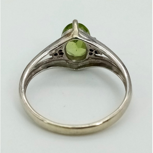 446 - A Vintage 9K White Gold Peridot Ring. Size N. 2.46g total weight.