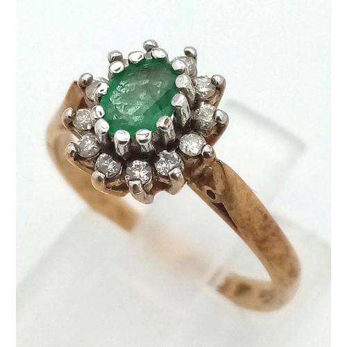 568 - A Vintage 9K Yellow Gold Emerald and Diamond Ring. Central oval emerald with a diamond surround. Siz... 