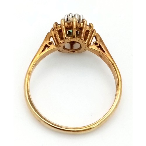 568 - A Vintage 9K Yellow Gold Emerald and Diamond Ring. Central oval emerald with a diamond surround. Siz... 